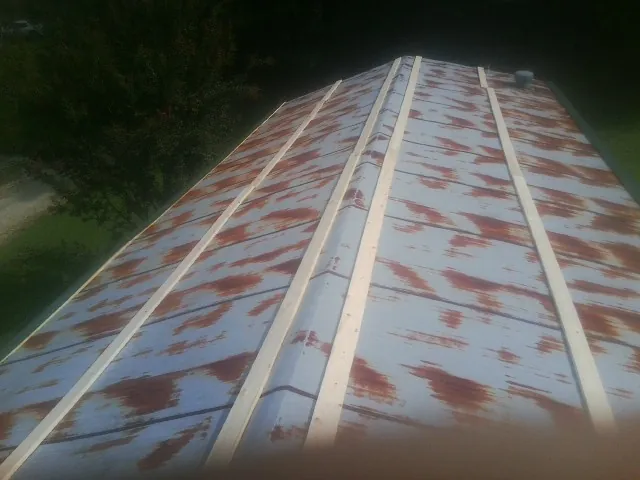 Rusted metal roof panels with new wood purlins before replacement — Storm Damage Roof Repair in Santa Clara by Roofing Brothers