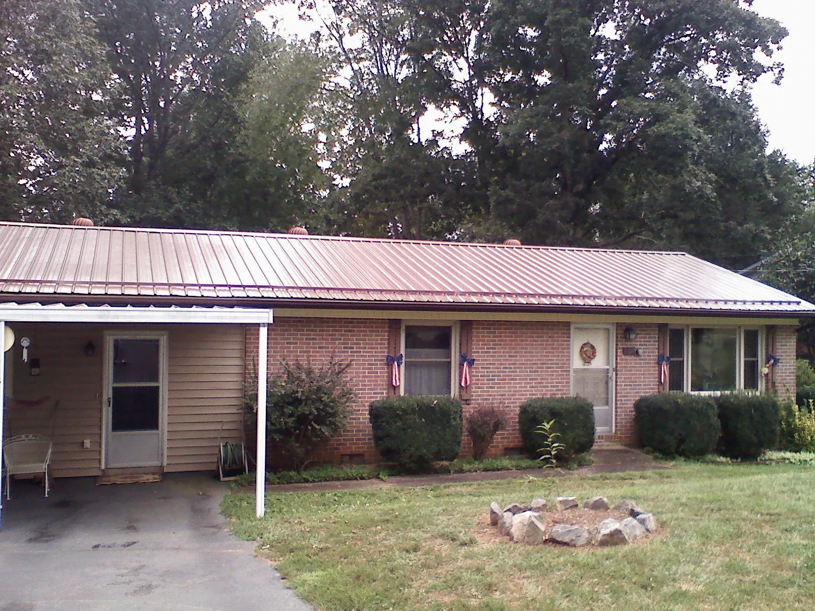 Bronze metal roof and carport on a brick ranch home — Roof Repair work by our crew in Santa Clara