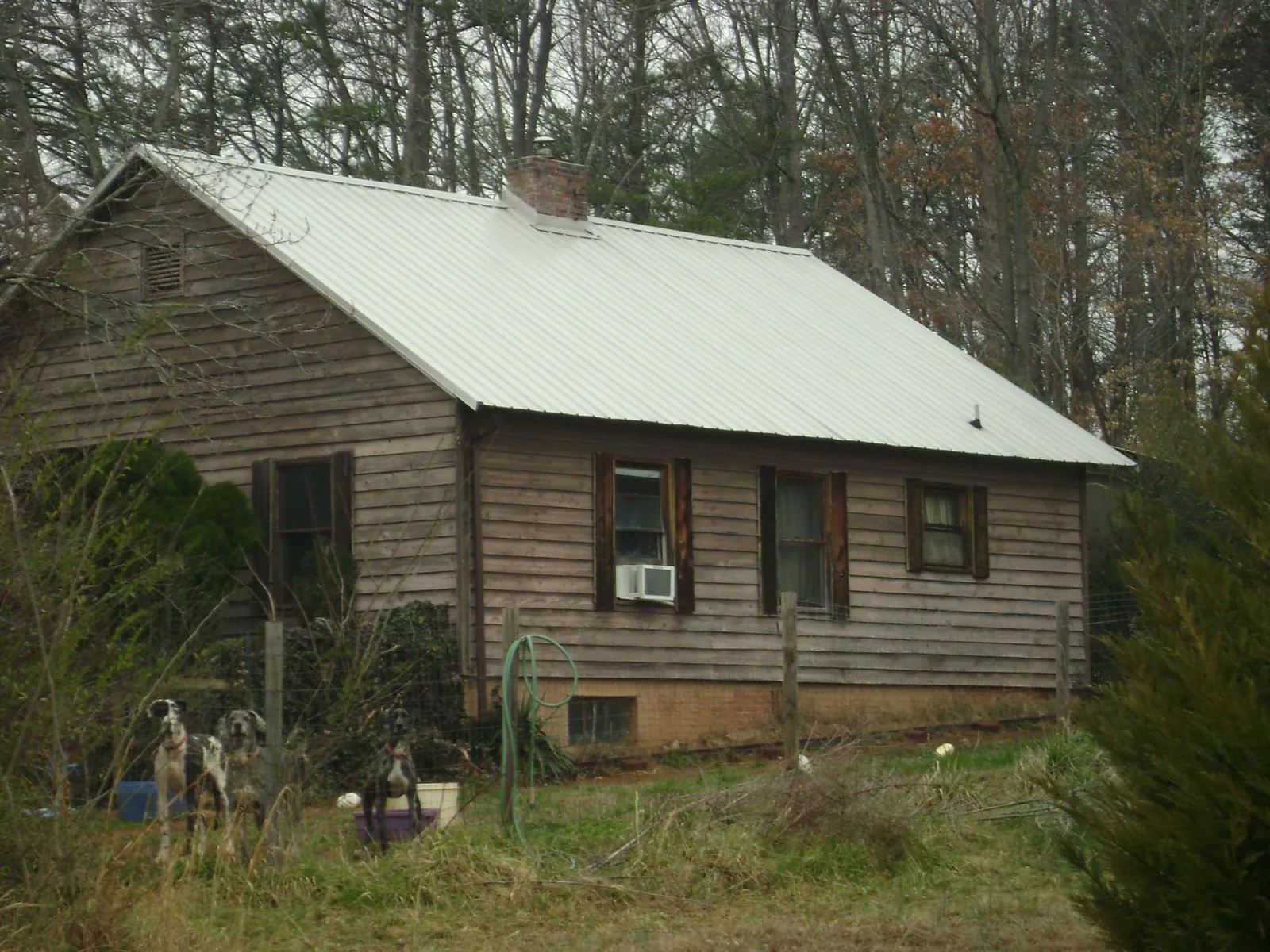 White metal roof on an old wood sided farmhouse, from a Metal Roof Installation job in Santa Clara